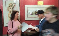 John and Sue Keller of Minden look over auction program in the bar area of the Mustang Ranch. - Andy Barron/RGJ